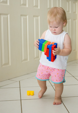 Toddler walking and playing with blocksの写真素材