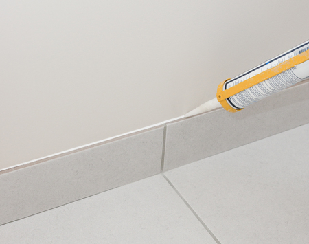 Builder filling gaps in preparation for paintingの写真素材