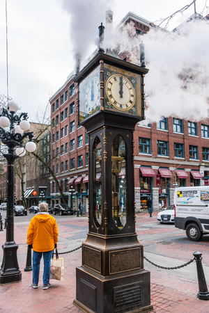 Vancouver, Canada - January 28, 2017: The historic steam clock strikes midday in Gastown, downtown Vancouver, with jets of steam rising from the clock.のeditorial素材