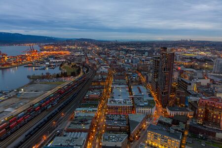 Vancouver, Canada - January 28, 2017: Vancouver cityscape at night with the harbour, Gastown and mountains in the background.のeditorial素材