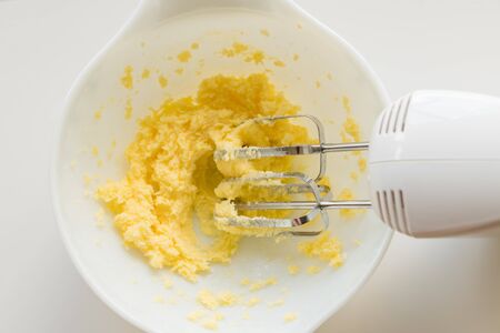 Preparing cookie dough with electric beaters in bowl