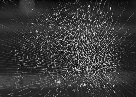 Closeup of broken pane of glass in a shop windowの写真素材