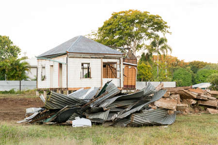 Corrugated iron roof sheeting in pile on building site with machineryの写真素材