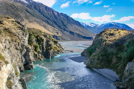 Landscape view of pure clean pristine aqua river flowing through a gorge in a valley between the mountainsの写真素材