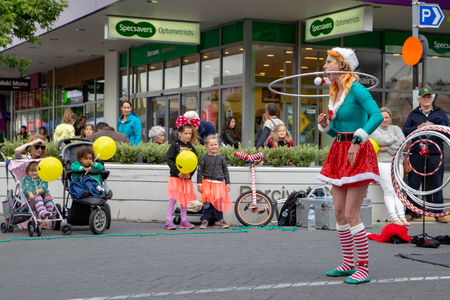 Rangiora, New Zealand - November 23 2018: An elf street performer entertains families at the Christmas community street market eveningのeditorial素材