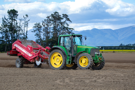 Shefffield, Canterbury, New Zealand - December 5 2018: A John Deere tractor and machinery on an agricultural farm preparing the soil for potato seedingのeditorial素材
