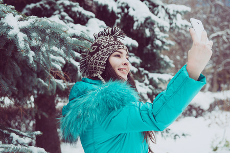 Portrait of a young girl in a winter parkの写真素材