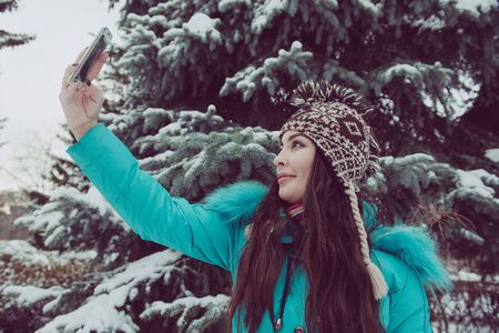 Portrait of a young girl in a winter parkの写真素材