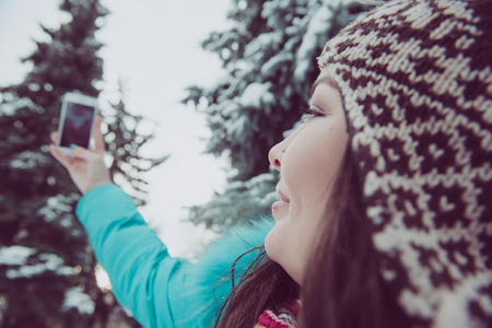Portrait of a young girl in a winter parkの写真素材