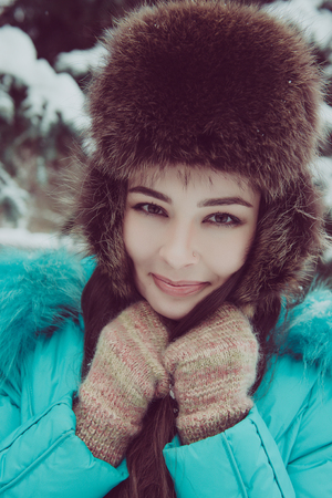 Portrait of a young girl in a winter parkの写真素材