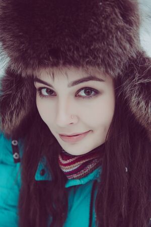 Portrait of a young girl in a winter parkの写真素材