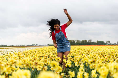 Lisse/Netherlands - 05/04/2019: Narcissus fields. Vacation in the Netherland, young woman.のeditorial素材
