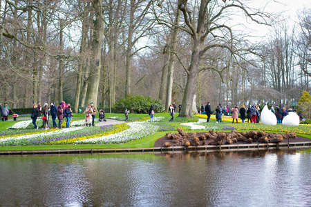 Lisse/Netherlands - 20/04/2019: Spring visiting season in Keukenhof park. Lakes and statues of the gardenのeditorial素材