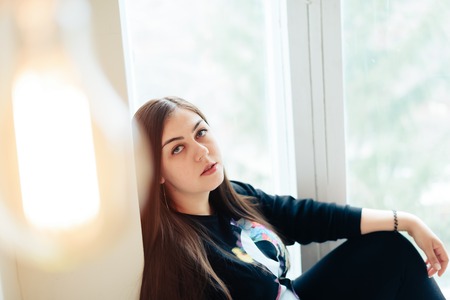 Brunette girl at home, interiorの写真素材