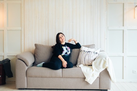Brunette girl at home, interiorの写真素材