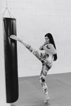 sports beautiful brunette girl in a blue jersey engaged in a gym 1の写真素材