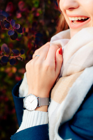 girl's hands on a background of autumn red leaves on a tree 1の写真素材