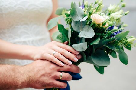 hands of the bride with a green wedding bouquet of flowers 1の写真素材