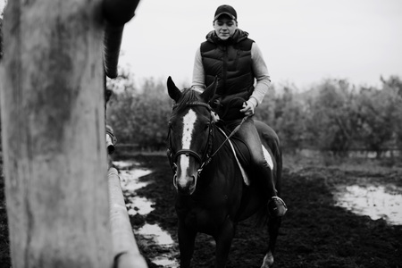 man learns riding a horse in autumn in a rural landscape 1