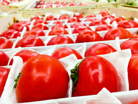 red juicy ripe tomatoes on the counter in the store 1の写真素材