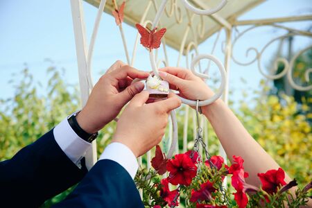 Newlyweds hang a lock on the fence
