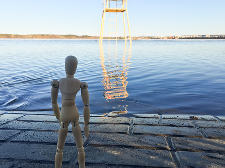wooden doll in the shape of a man on a background of natureの写真素材