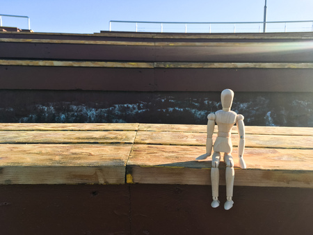 wooden doll in the shape of a man on a background of natureの写真素材