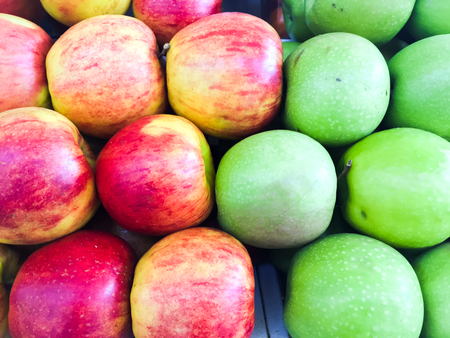 beautifully laid out vegetables and fruits on store shelvesの写真素材