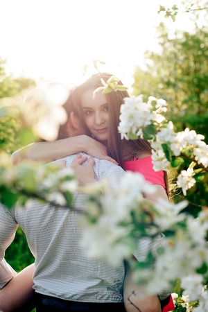 a young couple in love in the spring flowering Parkの写真素材