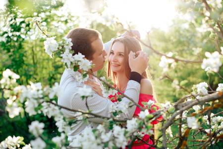 a young couple in love in the spring flowering Parkの写真素材