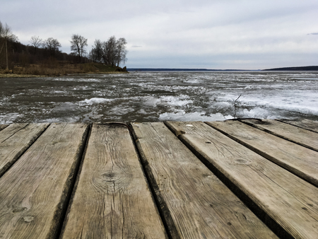landscape of a large lake in cloudy cold weatherの写真素材