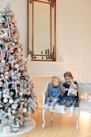 little boy and girl with Christmas decor, brother and sister for new year 1の写真素材
