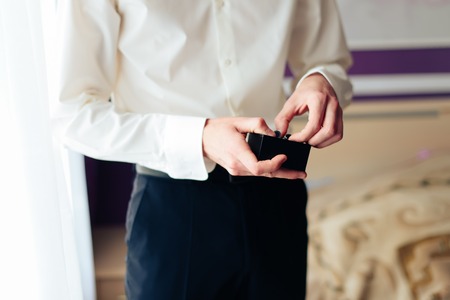 the morning of the groom, a handsome guy in a suit with a bow tie