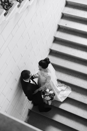 newlyweds in the apartment, a beautiful bride and groom in the rich interiorの写真素材