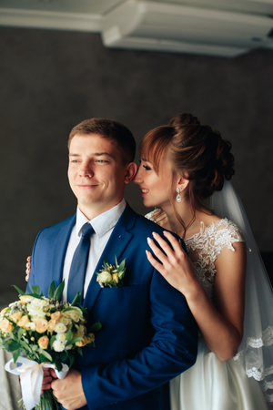 newlyweds in the apartment, a beautiful bride and groom in the rich interiorの写真素材