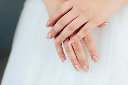 morning of the bride, a beautiful woman in a white dress is preparing for the wedding 1の写真素材