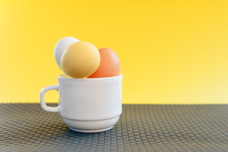 Easter eggs on yellow backgroundの写真素材