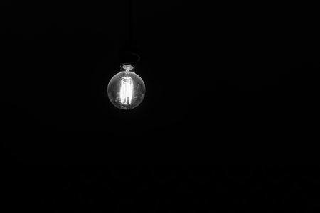 retro incandescent lamp on a black backgroundの写真素材