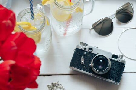 red flowers, retro camera and lemonade on a white backgroundの写真素材