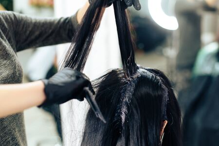 stylists work with the hair of a girl in a beauty salonの写真素材