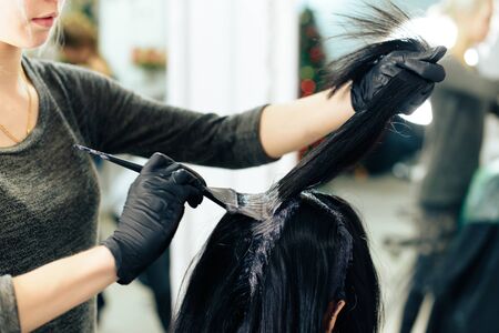 stylists work with the hair of a girl in a beauty salonの写真素材