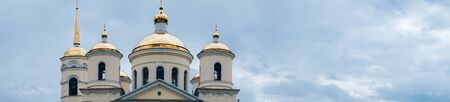panorama of the church in the blue sky with white cloudsの写真素材