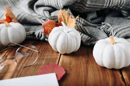 autumn set of pumpkins and dried leaves on a wooden backgroundの写真素材
