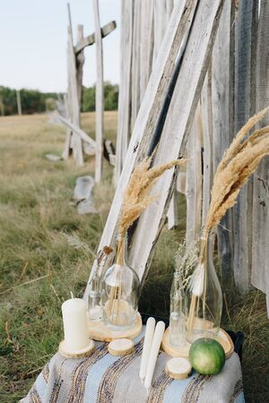 ears in a bottle outdoors against a wooden fence