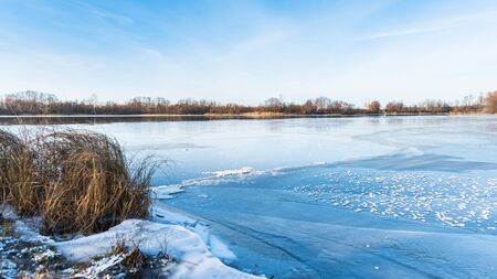 beautiful winter landscape of ice-covered riverの写真素材