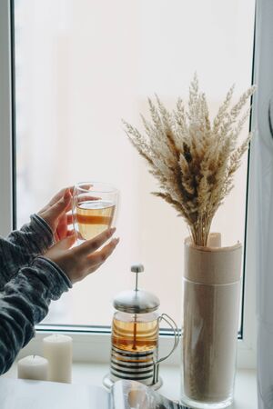 girl with a cup of hot tea in her handsの写真素材
