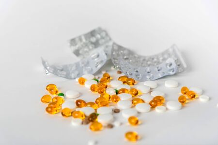 scattered pills of different shapes and colors on a white background 1の写真素材