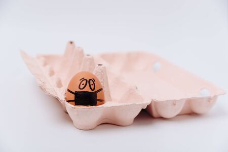 chicken egg with medical mask , Easter egg on white background