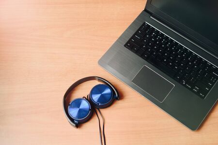 laptop and headphones on the desktop top viewの写真素材
