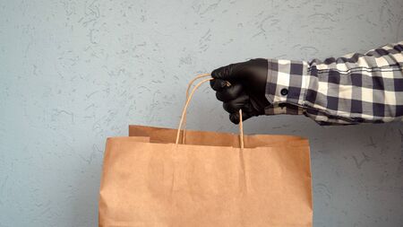 the courier passes a craft package with the product to the buyer, contactless delivery of food and other goods 1の写真素材